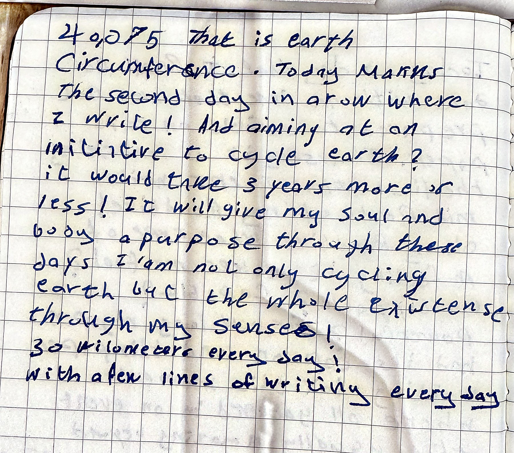 A squared notebook page opening with the figure 40,075 written in blue ink